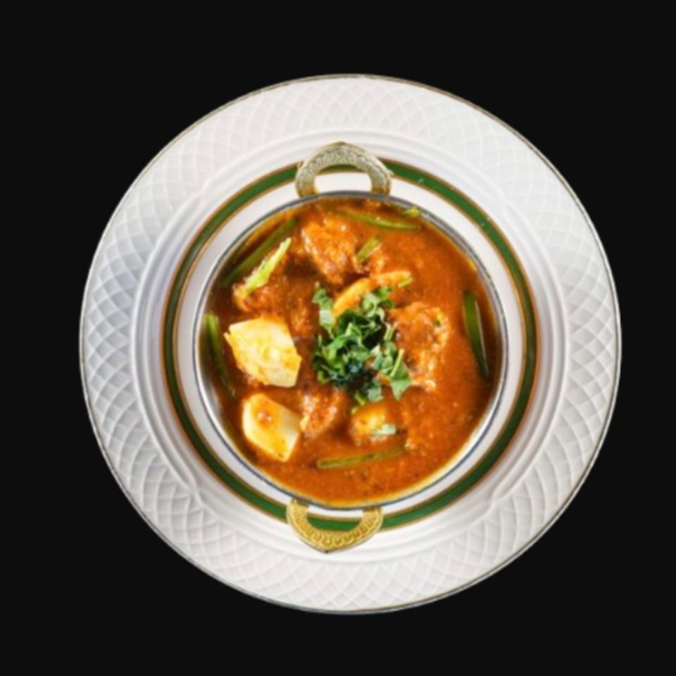Kalia Indian Cuisine's chicken curry with potatoes and green beans, garnished with cilantro.